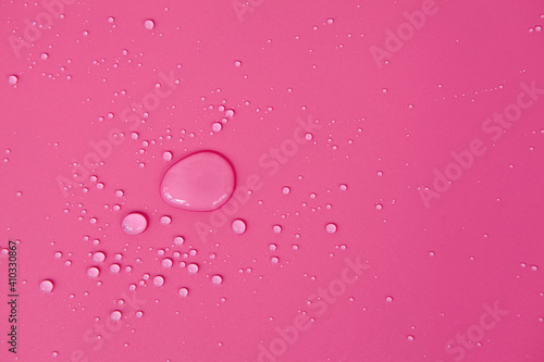 Full frame of the textures formed by the bubbles and drops of water. Drops of water spilled on a light pink surface