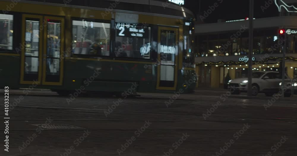 Night traffic. Cars and tram on paved street at night. Night traffic. Cars and tram on paved street at night.