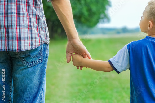 beautiful hands of parent and child outdoors in the park