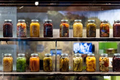 Fotografie wall of glass mason jars of colorful pickled vegetables, taken at Canadian Food