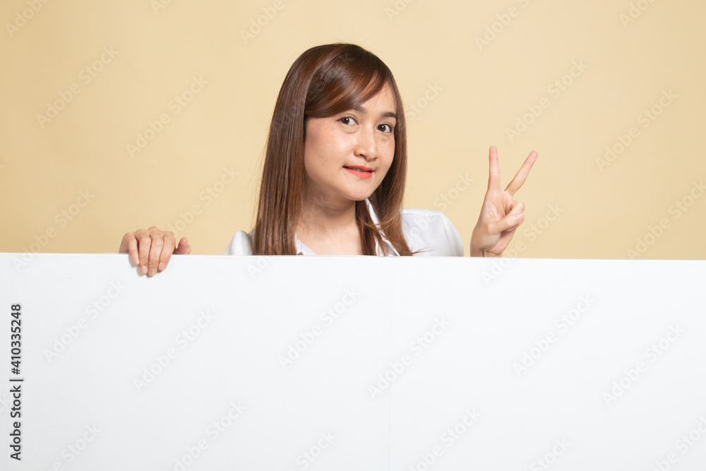 Young Asian woman show victory sign with blank sign. Young Asian woman show victory sign with blank sign.