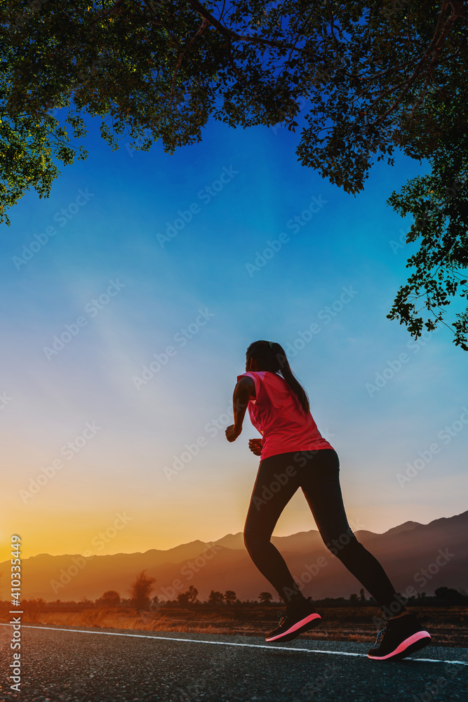 Young woman is running and jogging an outdoor workout on the road in the morning for lifestyle health.