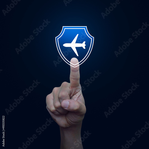 Hand pressing airplane with shield flat icon over blue gradient background  Business travel insurance and safety concept