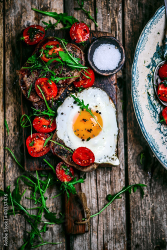 Tuscan steak with fried eggs and cherry tomatoes.selective focus.