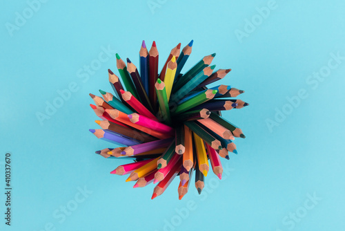 Top view of color pencils isolated on blue background