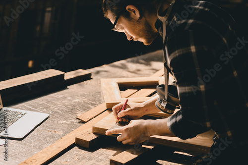 Carpenter man woodcraft working in furniture wood workshop with professional skill real people workman.