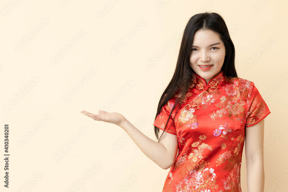 Chinese teen girl in present show giving or sale promotion posture dressing Qipao traditional cloth. Chinese teen girl in present show giving or sale promotion posture dressing Qipao traditional cloth.