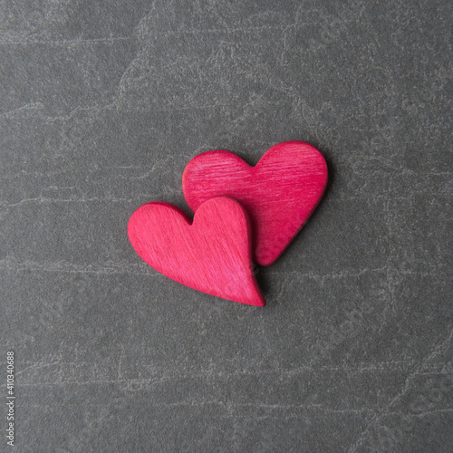 Pink decorative hearts on grey stone background with copy space. Valentine’s day concept
