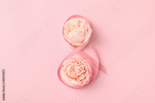 8 made of ribbon and roses on pink background