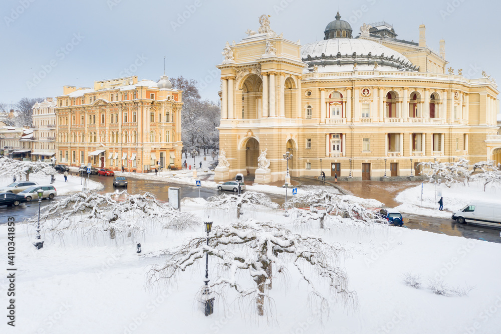 view to opera theatre through snow garden in Odessa in Ukraine in winter morning