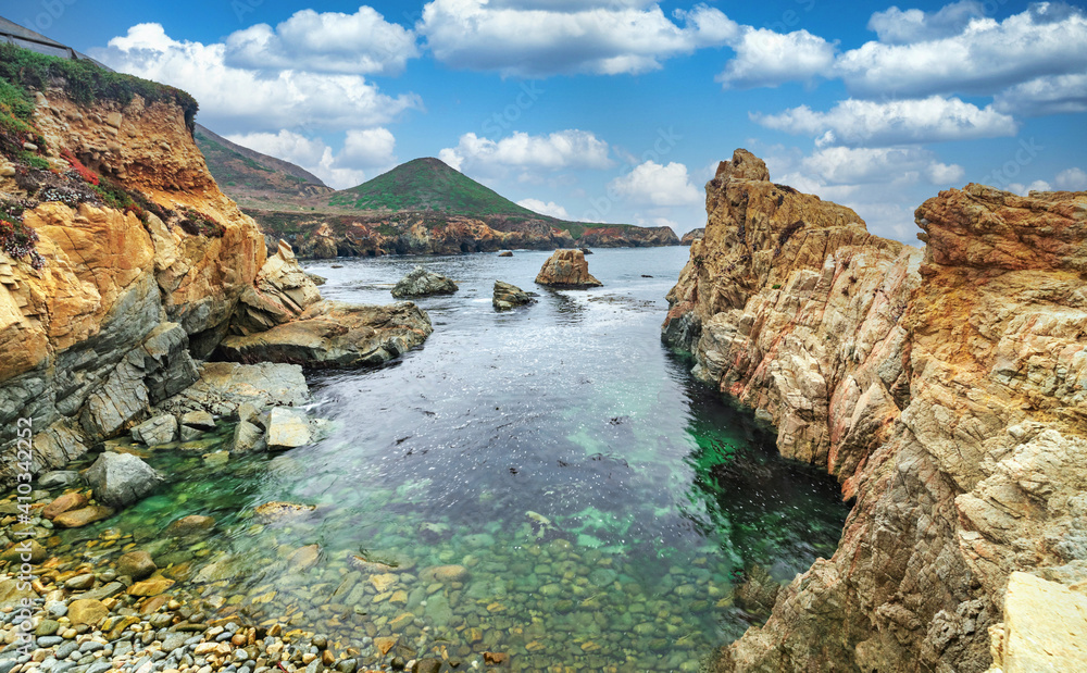 A beautiful view of a small cove in the Pacific Ocean, California, colorful landscape, bright sunny weather.