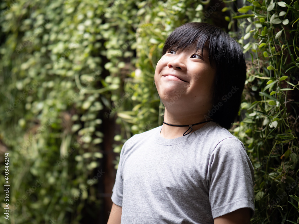 Funny portrait of young asian boy with funny face on blurred garden background Funny portrait of young asian boy with funny face on blurred garden background