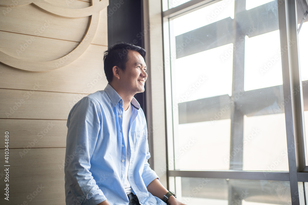 Portrait young man casual looking out window in office, Concept looking on future Portrait young man casual looking out window in office, Concept looking on future