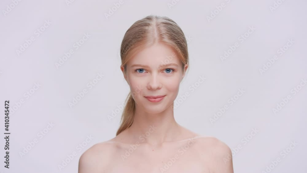 Young blonde beauty model looks at the camera through the finger frame Young blonde beauty model looks at the camera through the finger frame