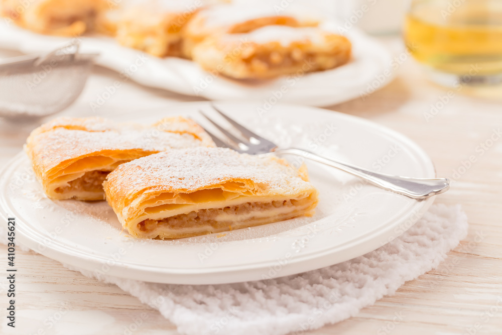 Homemade apple strudel (apfelstrudel) on white plate Homemade apple strudel (apfelstrudel) on white plate