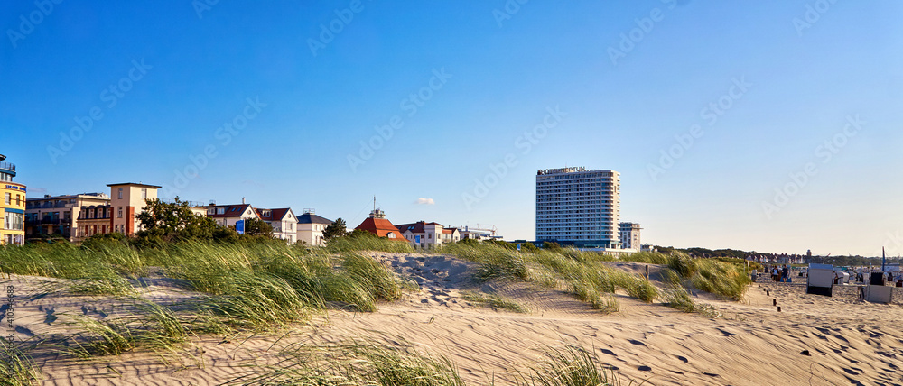 Panorama from the Hotel Neptun and the city of Warnemünde behind the dunes on the Baltic Sea beach. Panorama from the Hotel Neptun and the city of Warnemünde behind the dunes on the Baltic Sea beach.