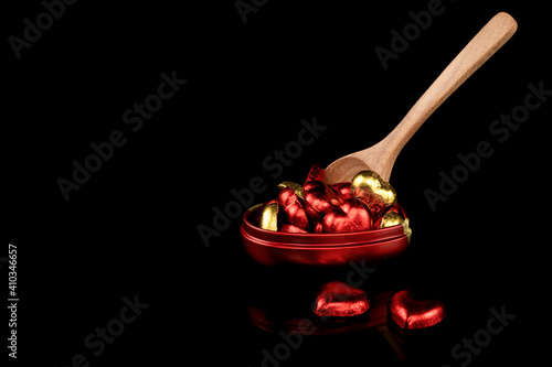 Heart shaped candies wrapped in red and gold foil