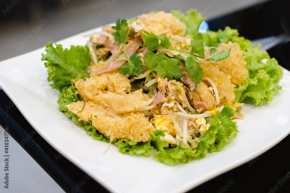 stir fried fish maw on white plate stir fried fish maw on white plate