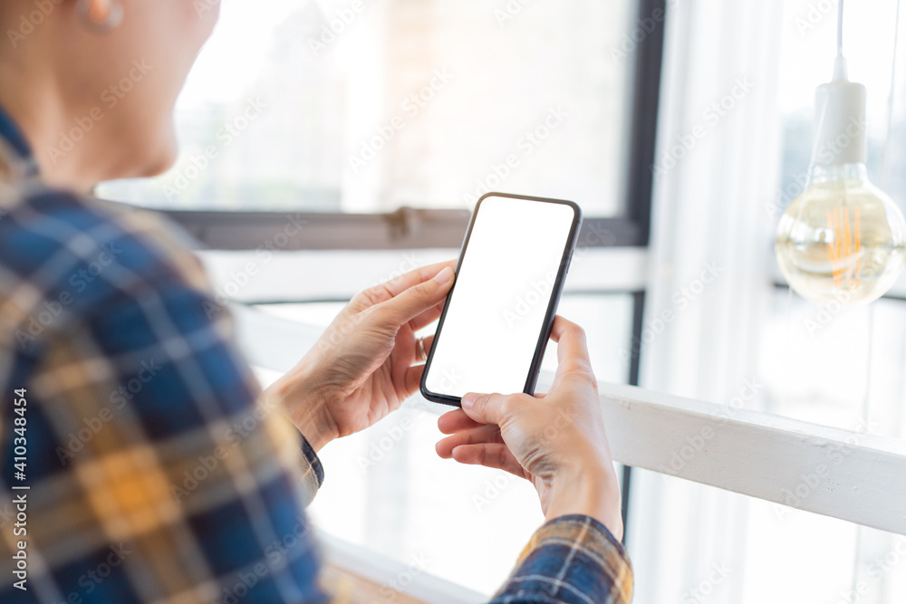 cell phone blank white screen mockup.woman hand holding texting using mobile on desk at office.background empty space for advertise.work people contact marketing business,technology cell phone blank white screen mockup.woman hand holding texting using mobile on desk at office.background empty space for advertise.work people contact marketing business,technology