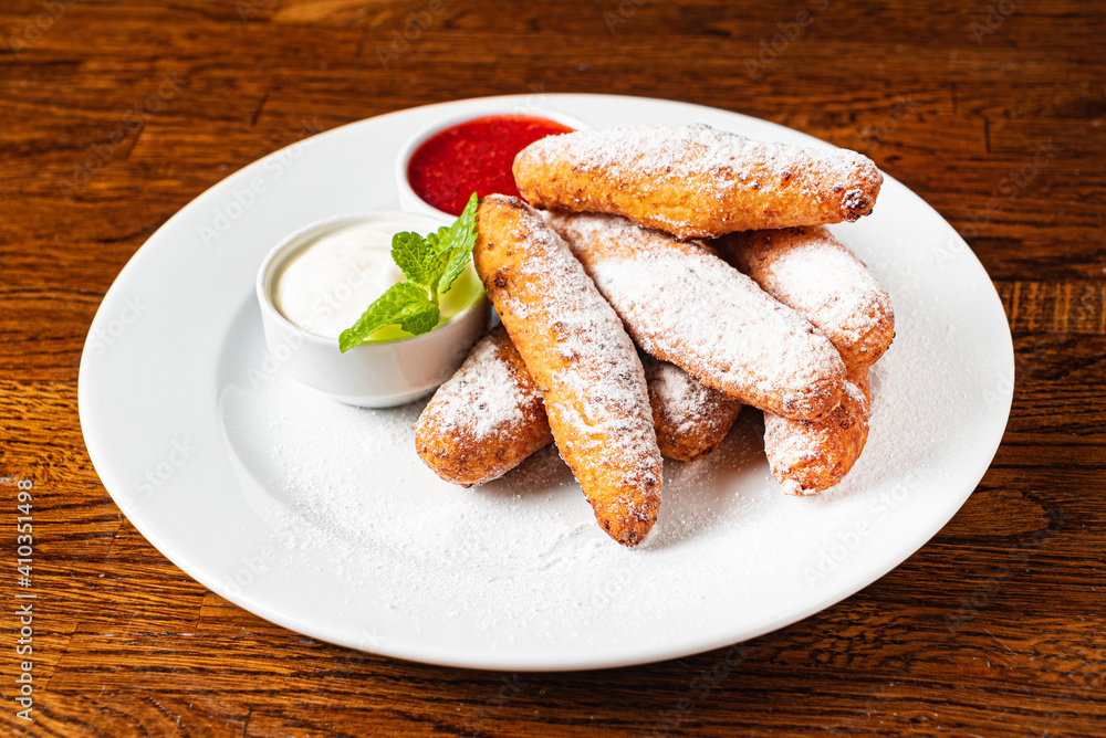 deep fried donuts with berry sauce