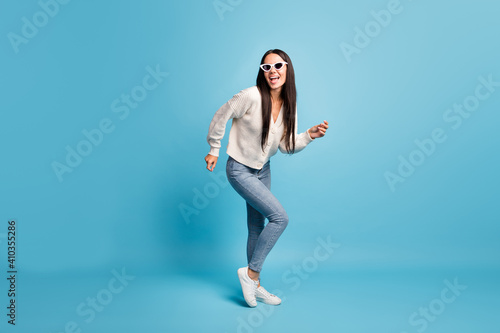 Full size portrait of crazy cheerful lady dancing enjoy clubbing open mouth isolated on blue color background