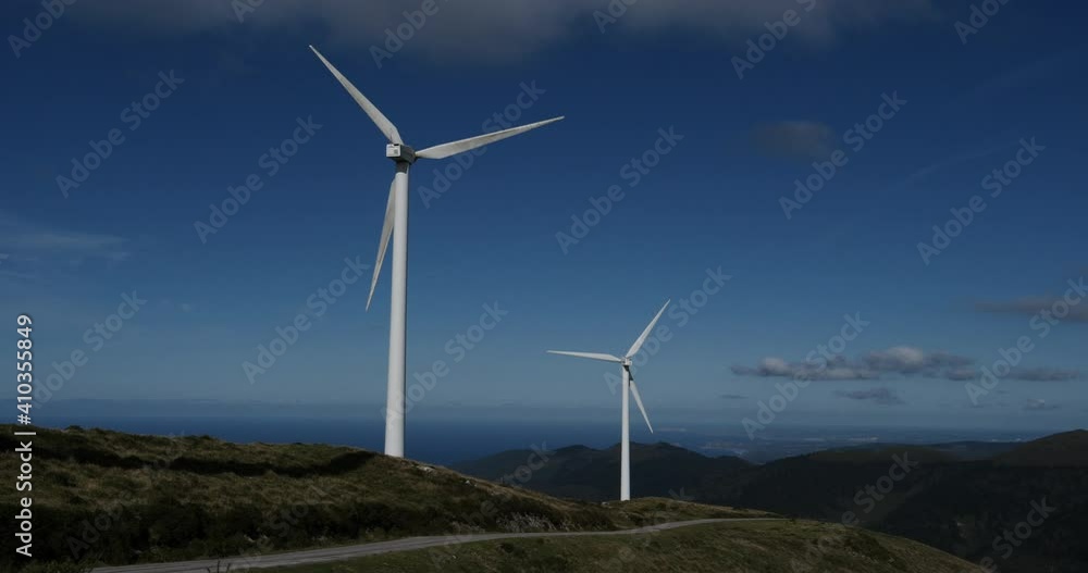 Clean energy, wind turbine park generating electricity with the sea in the background Clean energy, wind turbine park generating electricity with the sea in the background