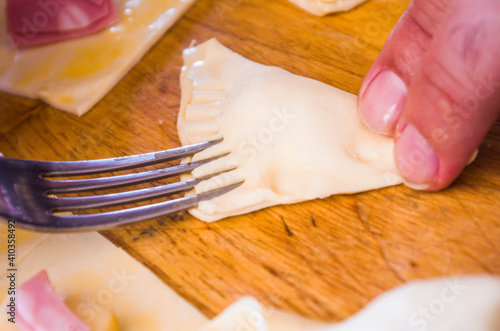 preparation of pretzels with cheese and mortadella cooked in the oven photo