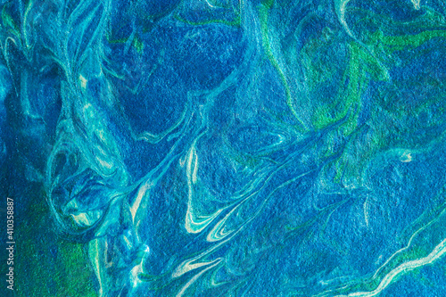 Turquoise blue abstract background in the technique of fluid art. liquid art pattern. Original art. Simulation of the depth of the ocean and the sea surface. Modern design. Drawing with acrylic paints