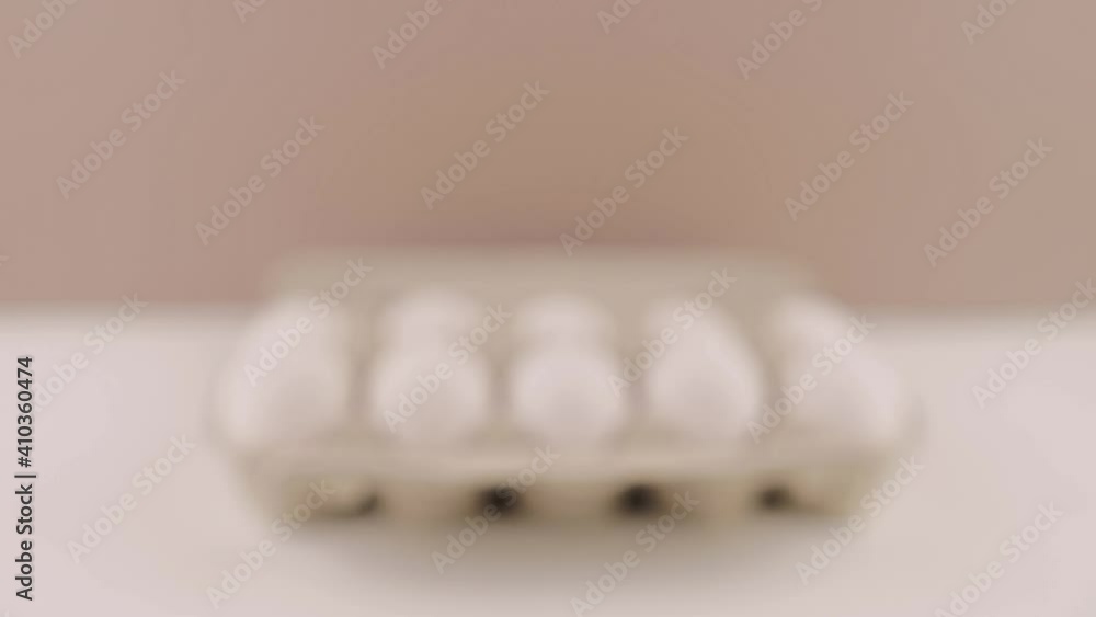 a fresh raw chicken eggs in a cardboard tray on a white background a fresh raw chicken eggs in a cardboard tray on a white background