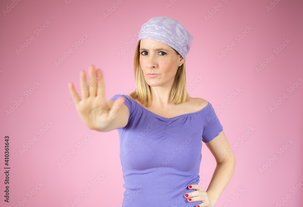 Portrait of a beautiful woman showing stop sign with palms isolated over pink background Portrait of a beautiful woman showing stop sign with palms isolated over pink background
