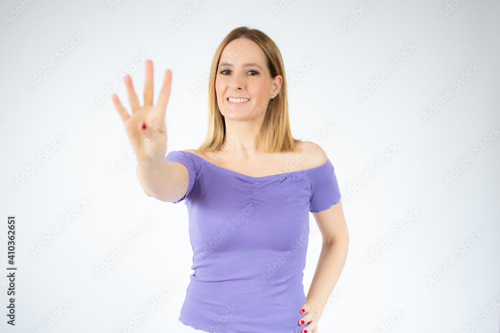 Young woman over isolated white background happy and counting four with fingers Young woman over isolated white background happy and counting four with fingers