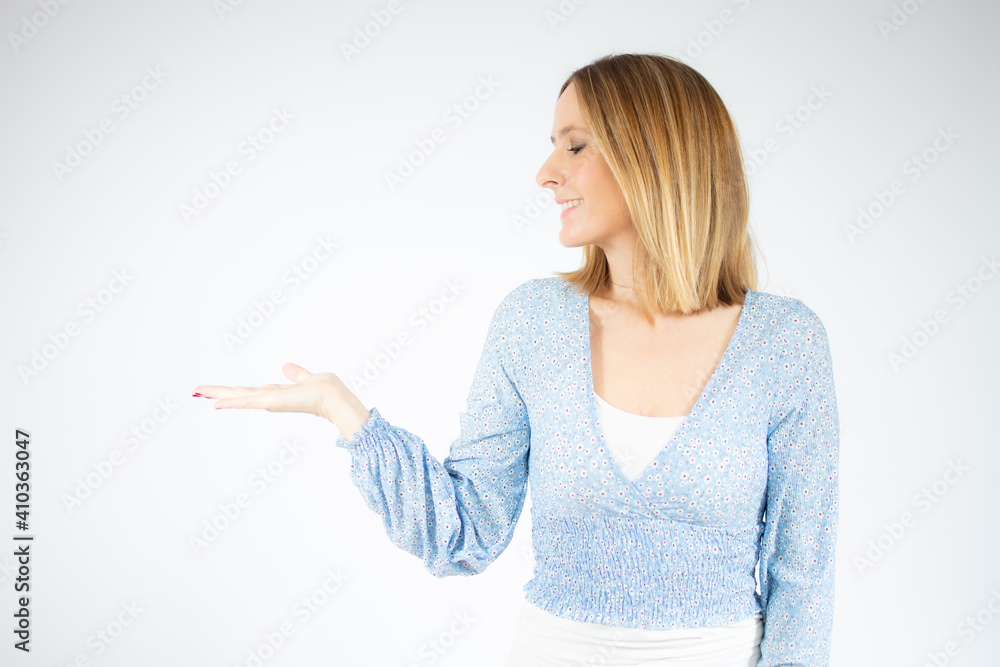 Young caucasian woman over isolated white background holding copy space imaginary on the palm Young caucasian woman over isolated white background holding copy space imaginary on the palm