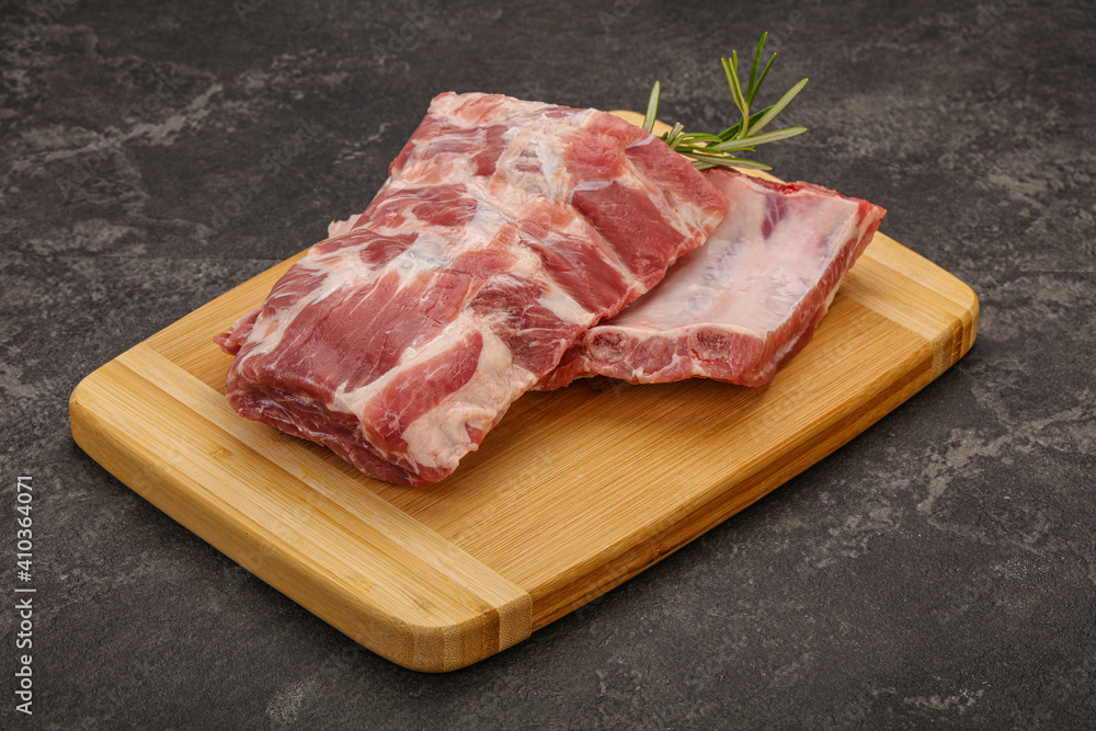 Raw pork ribs served rosemary