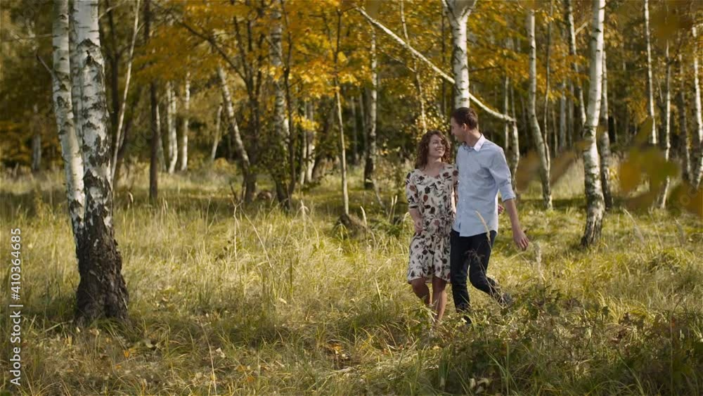 Young Couple in Love Holding Hands Together in Forest. Young Couple in Love Holding Hands Together in Forest.
