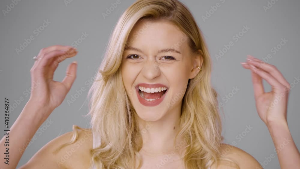 Charming woman playing with hair in studio Charming woman playing with hair in studio