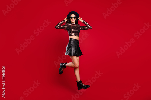 Full body profile side photo of happy nice girl jump up air wear boots isolated on red color background