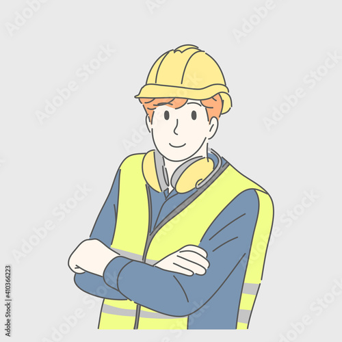 Engineer man wearing helmet and crossing arms.