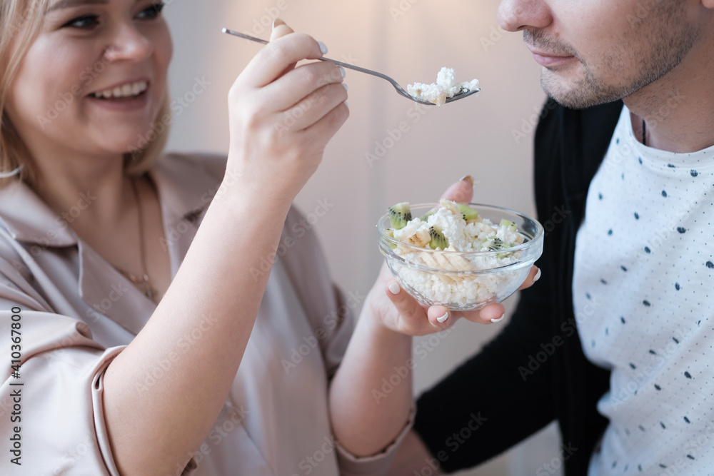 Beautiful young couple is having breakfast in the kitchen. Beautiful young couple is having breakfast in the kitchen.