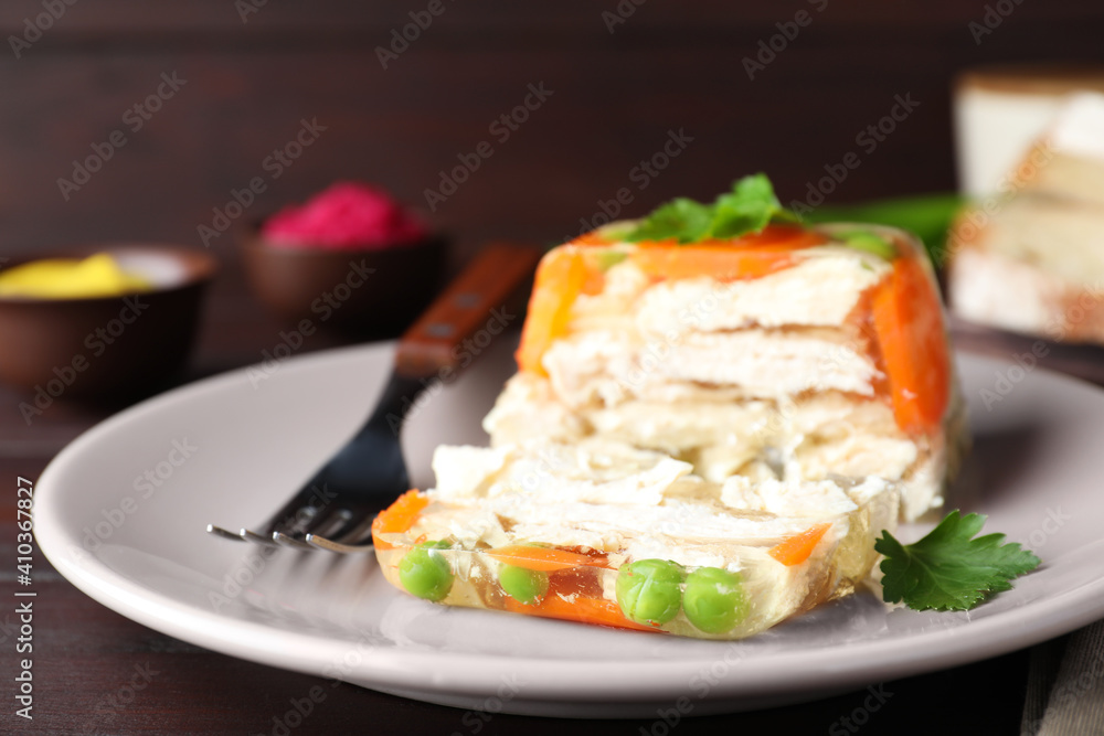 Delicious chicken aspic served on wooden table, closeup