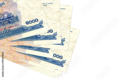 1000 Cambodian riels bills lies in small bunch or pack isolated on white. Mockup with copy space. Business and currency exchange photo