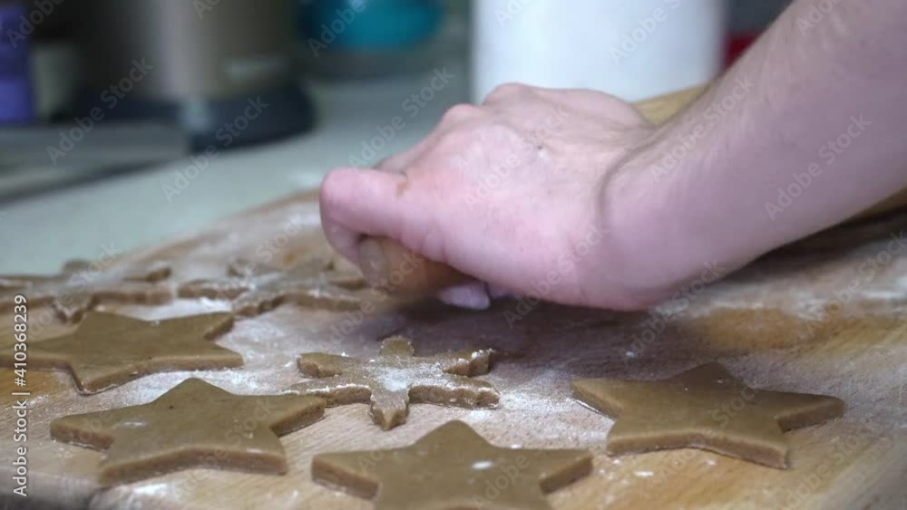 Caucasian female working on gingerbread dough with a rolling pin. Caucasian female working on gingerbread dough with a rolling pin.