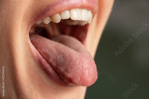 open mouth tongue lips of a young girl close-up photo
