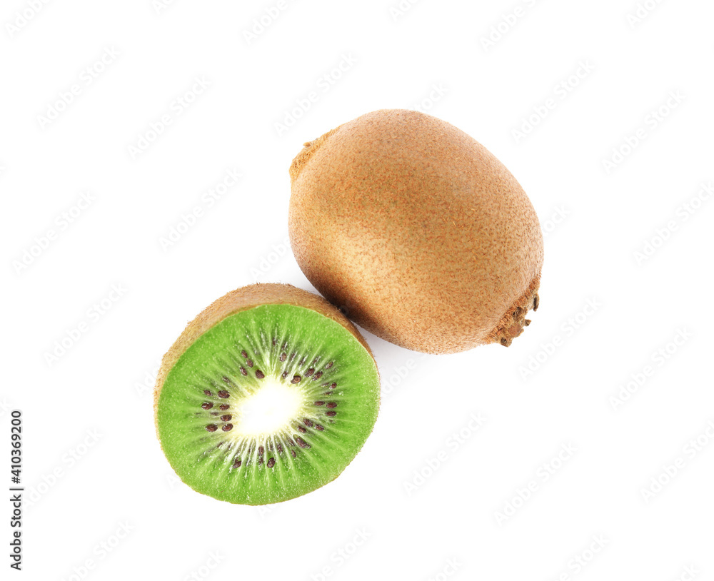 Obraz premium Cut and whole fresh kiwis on white background, top view