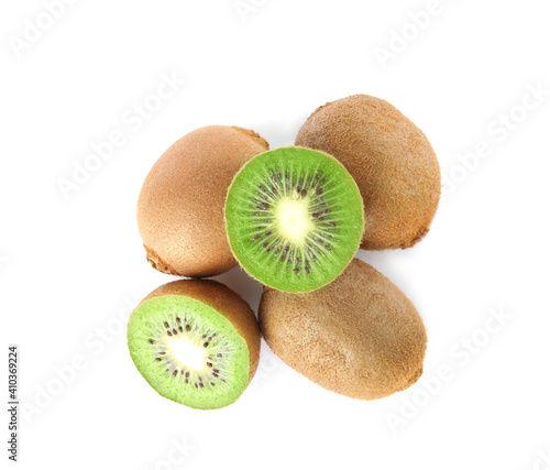 Cut and whole fresh kiwis on white background, top view