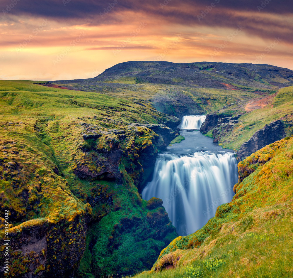 Beautiful Icelandic scenery. Fabulous waterfall on Skoga river. Stunning summer sunrise in outskirts of Skogafoss waterfall. Exciting morning scene of Iceland. Beauty of nature concept background..