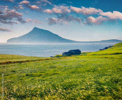 Spectacular summer view of Sydradalur village with typical turf-top houses. Impressive morning scene of Streymoy island, Faroe, Denmark, Europe. Traveling concept background. photo