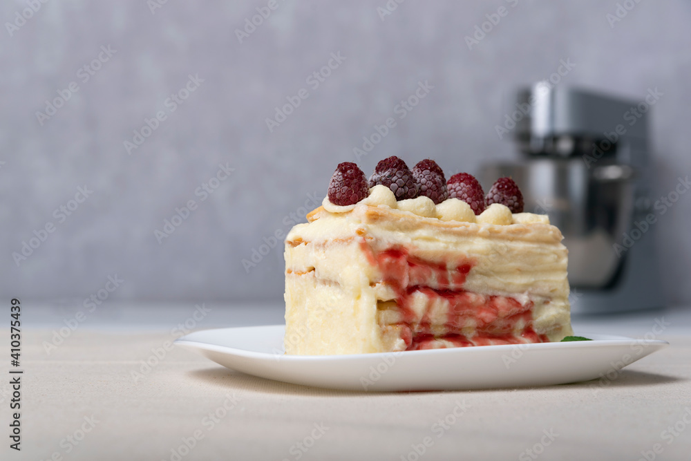 Piece of vanilla slice cake, fruit syrup and berries. Close up. Piece of vanilla slice cake, fruit syrup and berries. Close up.