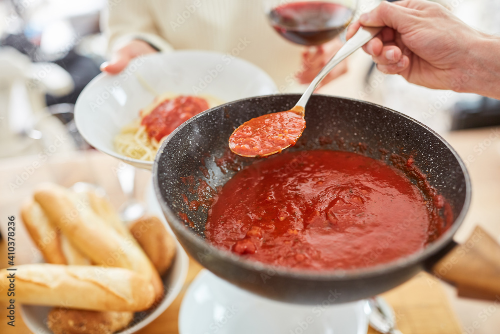 Tomato sauce is served with pasta at the table for meal Tomato sauce is served with pasta at the table for meal