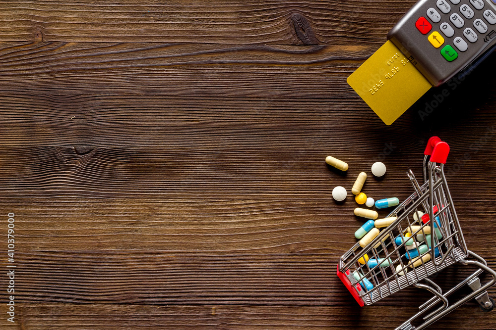 Grocery cart with pills and medicine. Online pharmacy shopping concept Grocery cart with pills and medicine. Online pharmacy shopping concept