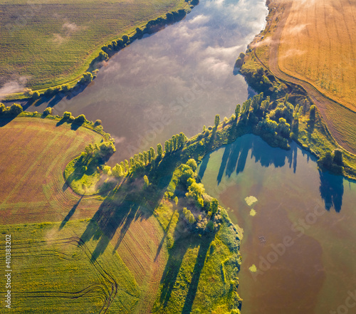 Straight down view from flying drone of dam on the lake. Misty morning scene of countryside, Ternopil region, Angelivka lake. Bright summer landscape on Ukraine, Europe. photo